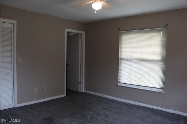 carpeted empty room featuring ceiling fan