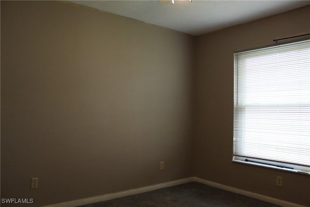 empty room featuring dark carpet