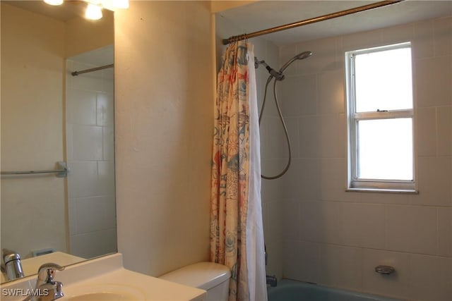 full bathroom featuring toilet, shower / bath combo, and vanity