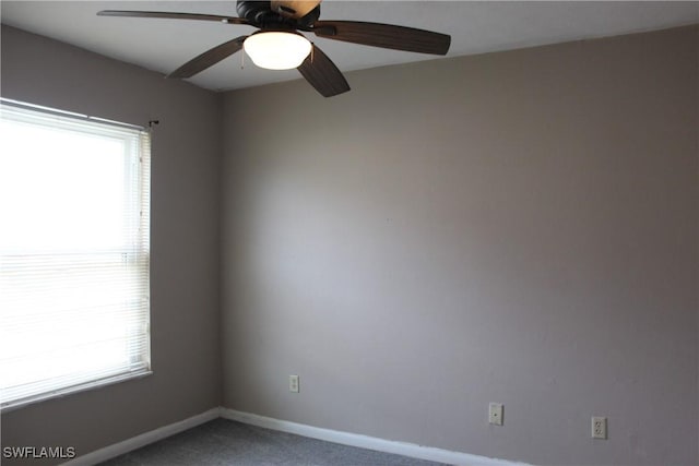 carpeted spare room with ceiling fan