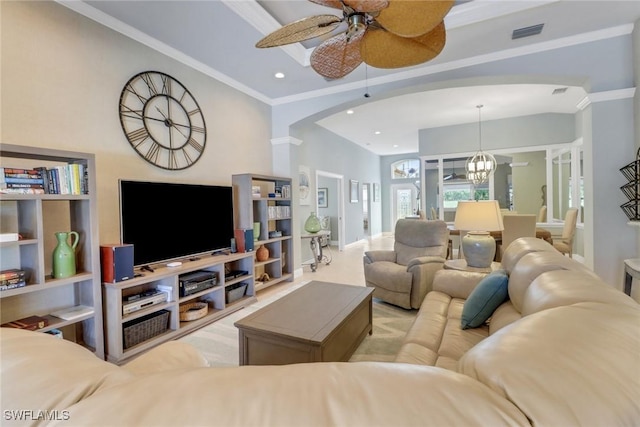 living room featuring ornamental molding and ceiling fan with notable chandelier