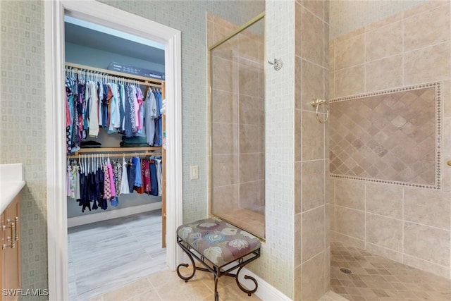 14113 Tivoli Ter, Bonita Springs, FL 34135 - bathroom featuring vanity, a stall shower, a spacious closet, and tile patterned floors