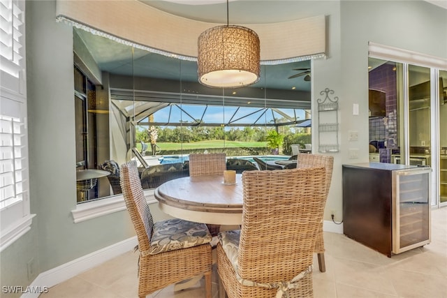 14113 Tivoli Ter, Bonita Springs, FL 34135 - tiled dining space featuring a sunroom, plenty of natural light, a ceiling fan, and wine cooler