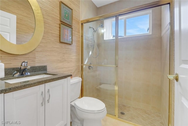 bathroom with vanity, toilet, and walk in shower