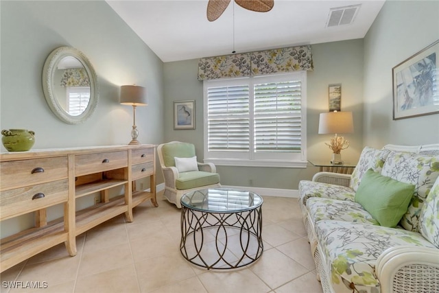 living area featuring light tile patterned floors and ceiling fan