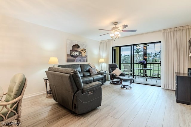 living room with ceiling fan and light hardwood / wood-style floors