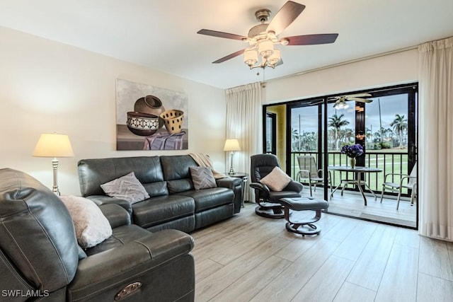 living room featuring ceiling fan and light wood-type flooring