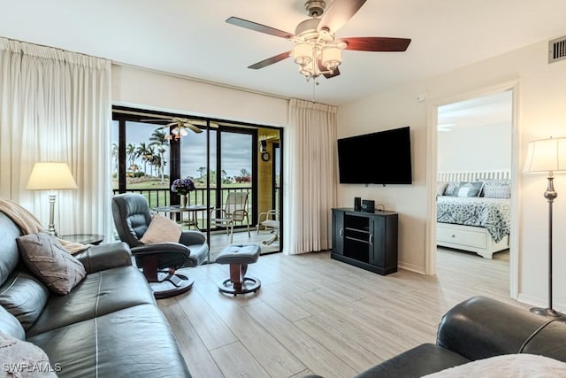 living room with light hardwood / wood-style floors and ceiling fan