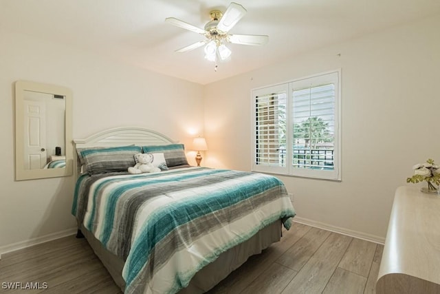 bedroom with ceiling fan and wood-type flooring