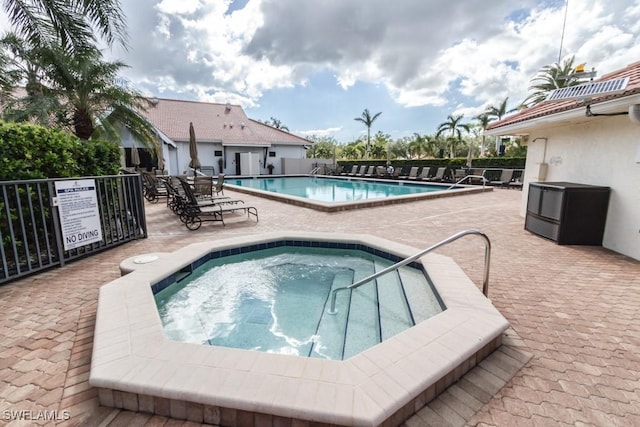 view of swimming pool with a community hot tub