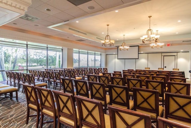 interior space featuring a raised ceiling and a chandelier