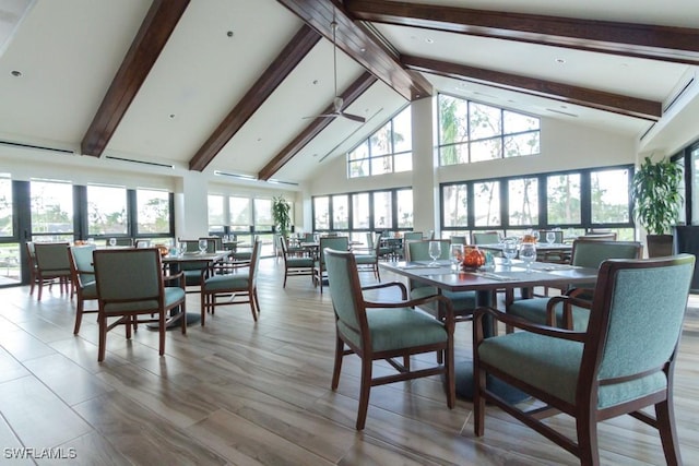 dining area featuring high vaulted ceiling and beamed ceiling