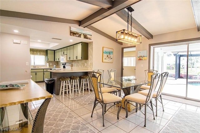 dining space featuring sink, light tile patterned floors, and lofted ceiling with beams