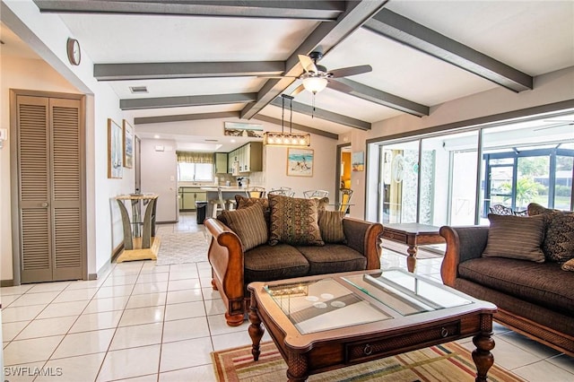 living room with ceiling fan, light tile patterned floors, and lofted ceiling with beams