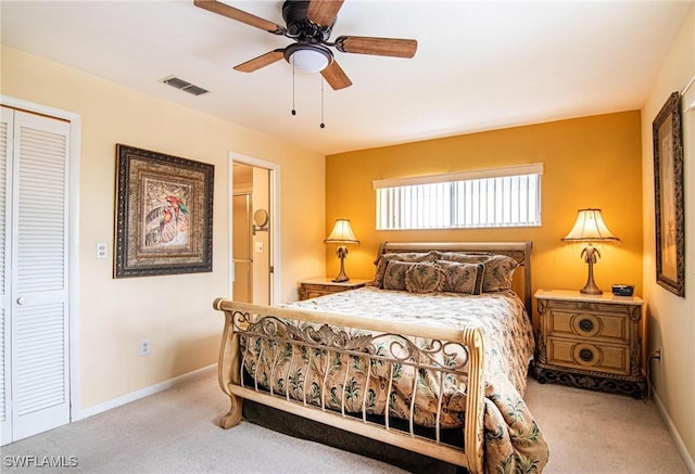 bedroom featuring ceiling fan, light colored carpet, and a closet