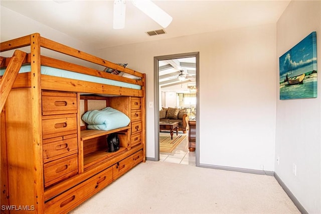 bedroom with vaulted ceiling, ceiling fan, and light colored carpet