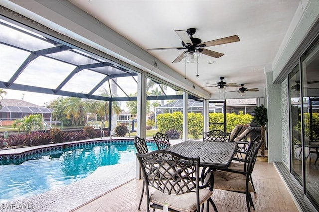 view of pool with ceiling fan, a lanai, and a patio