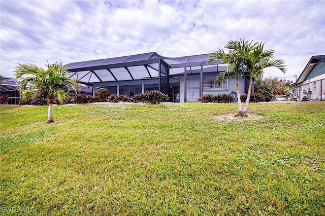 exterior space with a lanai and a lawn