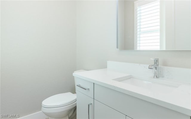 bathroom with toilet and vanity