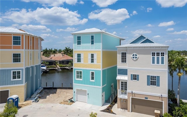 exterior space featuring a water view and a garage