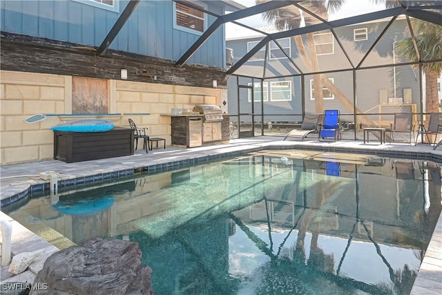 view of pool with a patio, glass enclosure, and area for grilling