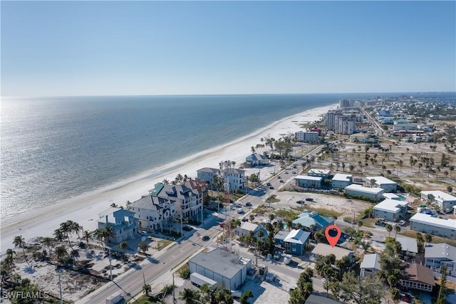 drone / aerial view featuring a water view and a beach view