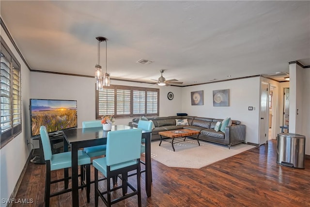 dining room with ceiling fan, dark hardwood / wood-style flooring, and crown molding