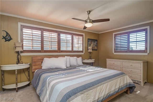 bedroom with ceiling fan, light carpet, and crown molding