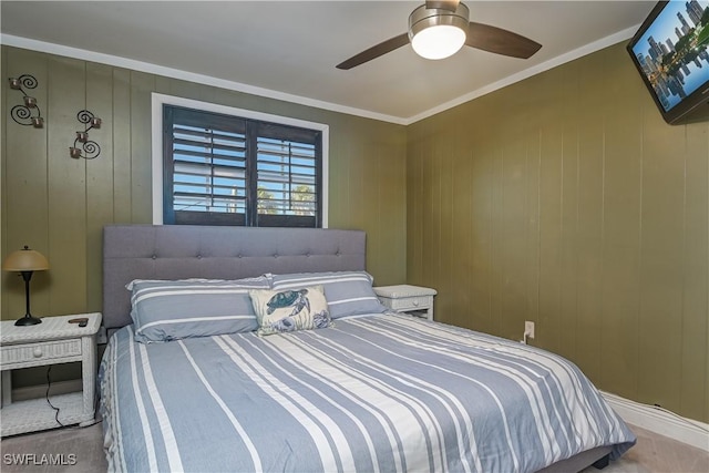 bedroom featuring ceiling fan, ornamental molding, and wooden walls