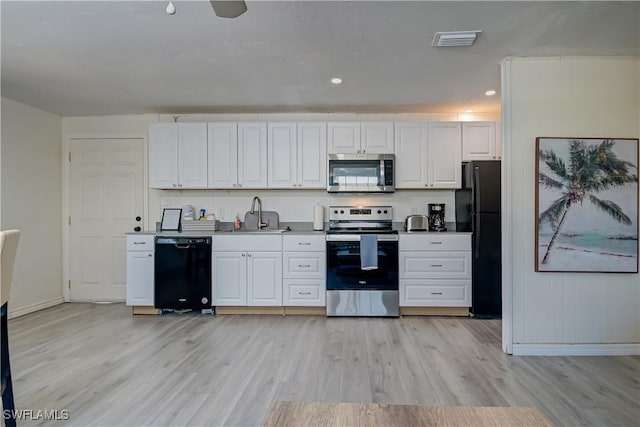 kitchen featuring light hardwood / wood-style floors, sink, white cabinetry, and black appliances