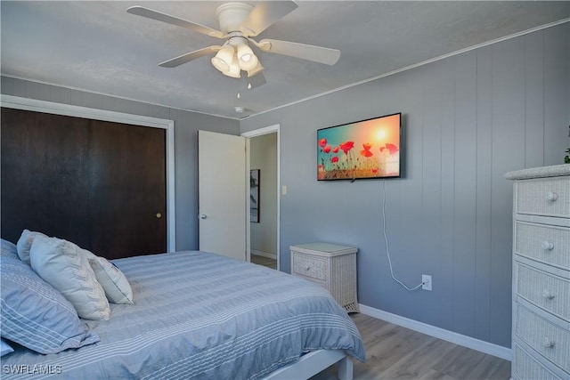 bedroom with ceiling fan and light hardwood / wood-style floors