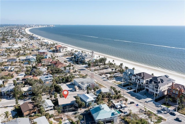 bird's eye view featuring a water view and a beach view