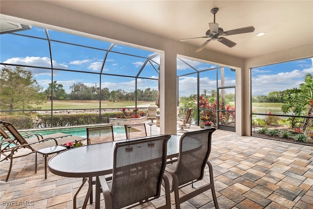 sunroom / solarium featuring ceiling fan