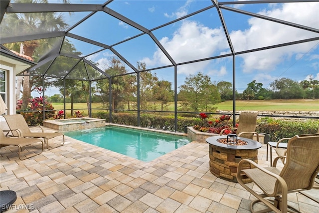 view of pool with glass enclosure, a patio area, an in ground hot tub, and a fire pit