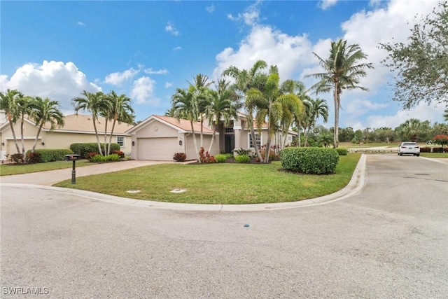 view of front of house with a garage and a front lawn