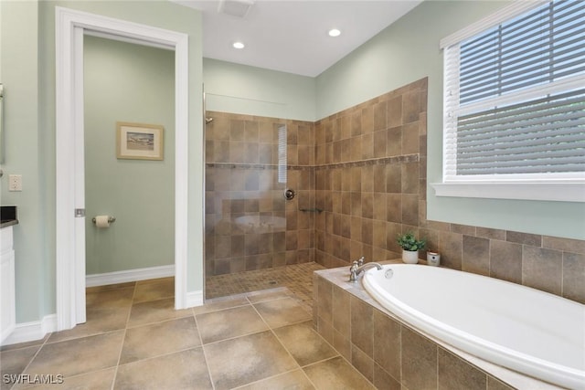 bathroom with independent shower and bath and tile patterned flooring