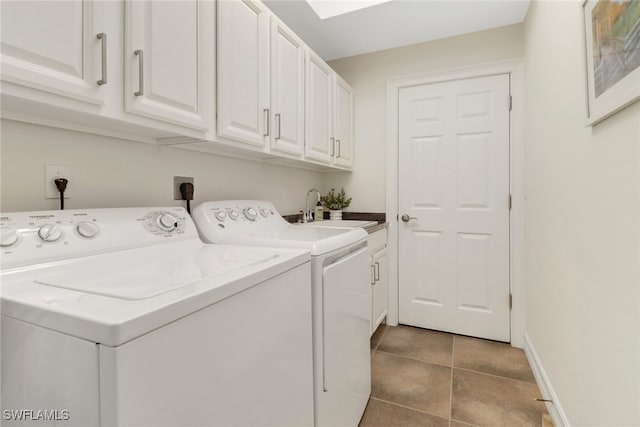 laundry room with light tile patterned floors, sink, washer and dryer, and cabinets