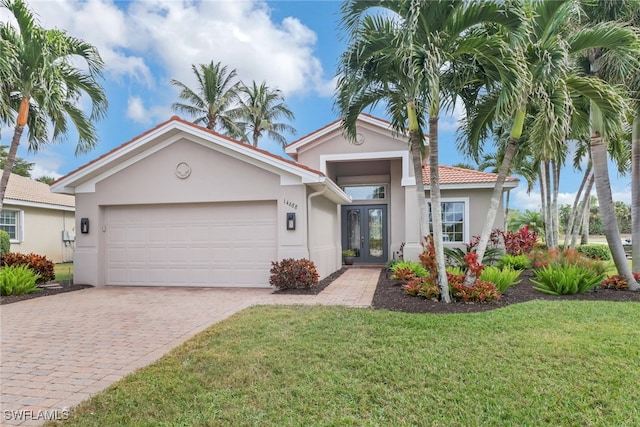 view of front of home featuring a garage, a front lawn, and french doors