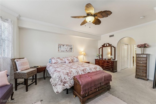 bedroom with light carpet, crown molding, and ceiling fan