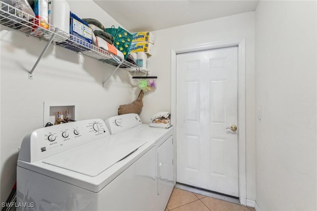 washroom featuring independent washer and dryer and light tile patterned flooring