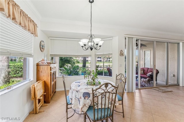 tiled dining area featuring ornamental molding and a notable chandelier