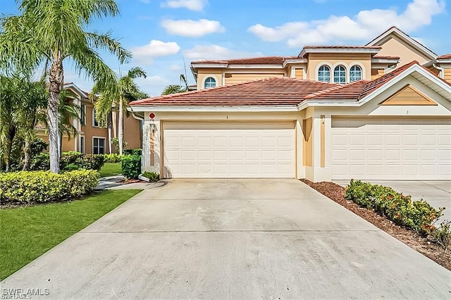 mediterranean / spanish-style house with a garage