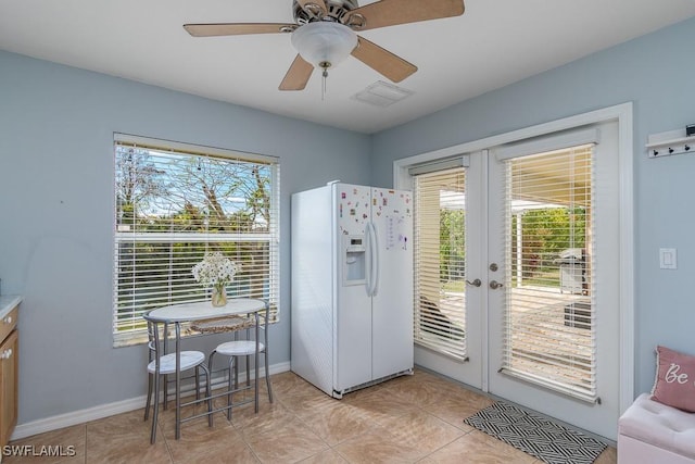 entryway featuring ceiling fan, light tile patterned floors, and french doors