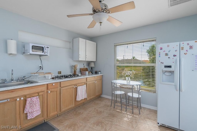 kitchen featuring ceiling fan, white appliances, light tile patterned flooring, white cabinets, and sink