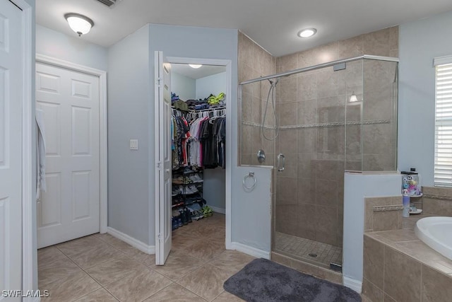 bathroom with separate shower and tub, a healthy amount of sunlight, and tile patterned floors