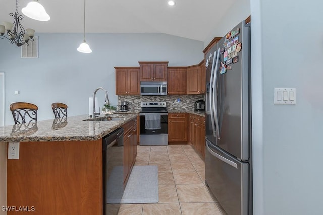 kitchen with an inviting chandelier, stainless steel appliances, tasteful backsplash, hanging light fixtures, and sink