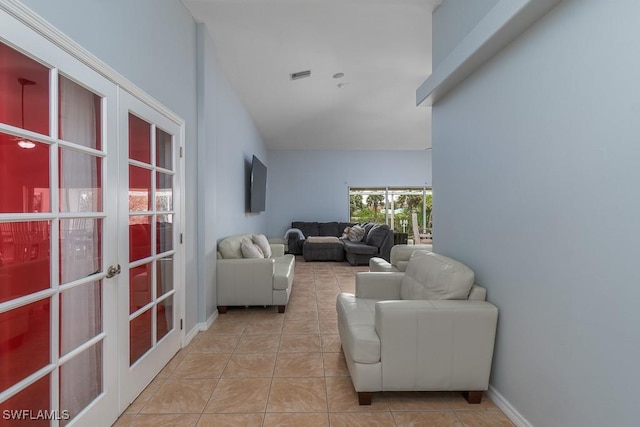 living room featuring french doors and light tile patterned flooring