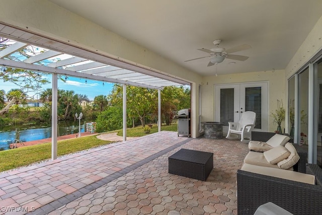 view of patio with a pergola, ceiling fan, an outdoor hangout area, area for grilling, and a water view