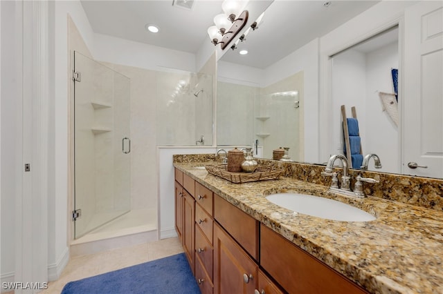 bathroom with vanity, tile patterned floors, and a shower with door