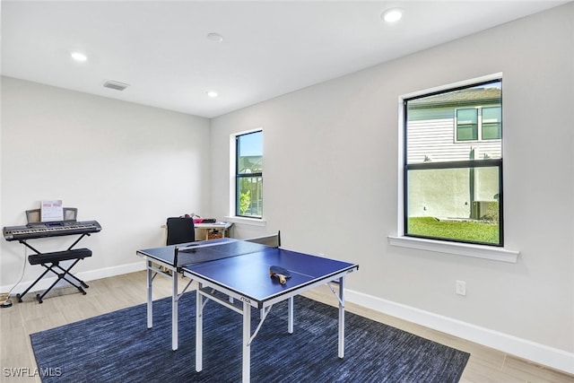 rec room featuring a wealth of natural light and light hardwood / wood-style flooring